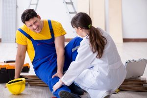 Worker with injured leg and doctor implementing a safety program that includes return to work. 