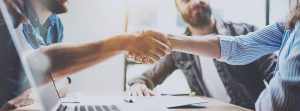 Handshake while a Small Business Owner attempts to hire the right employee. 