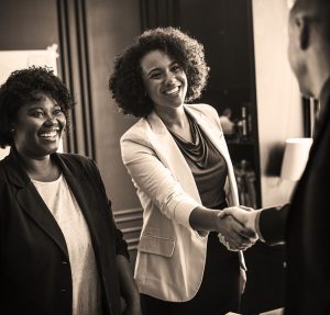 Business Handshake with a small business owner and their insurance agent at renewal. 