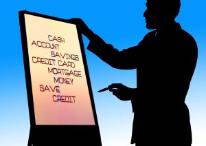 Graphic photo of a man giving a presentation. On the presentation screen are the words Cash, Account, Savings, Credit Card, Mortgage, Money, Save, Credit