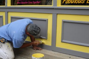 Painter finishing a job before turning over a new house to its owner. 